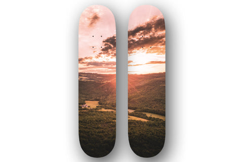 Ce diptyque sur des planches de skateboard, un coucher de soleil majestueux sur des planches de skateboard. 